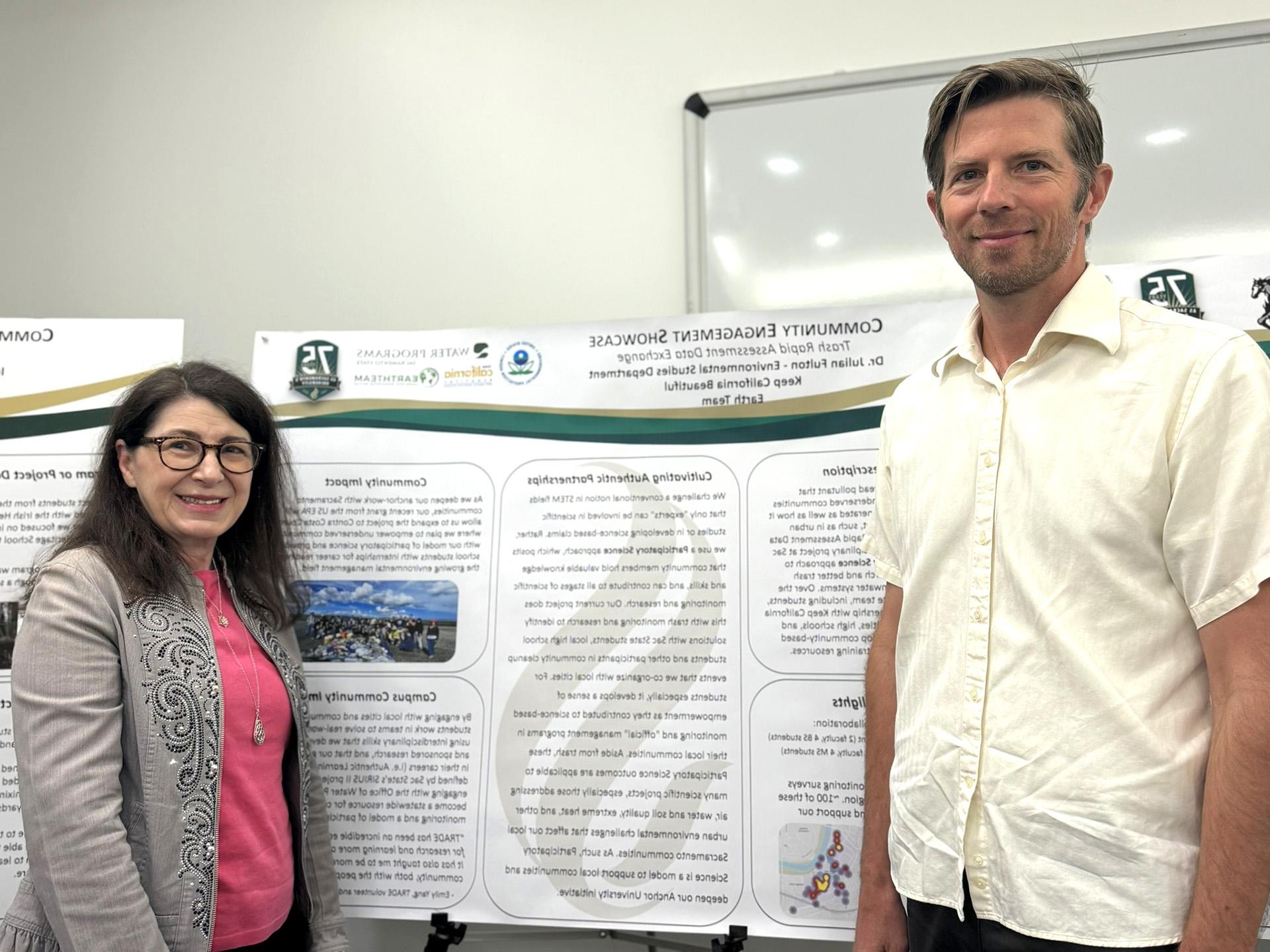 Julian Fulton and Cecile Carson standing in front of a poster board outlining the TRADE program.